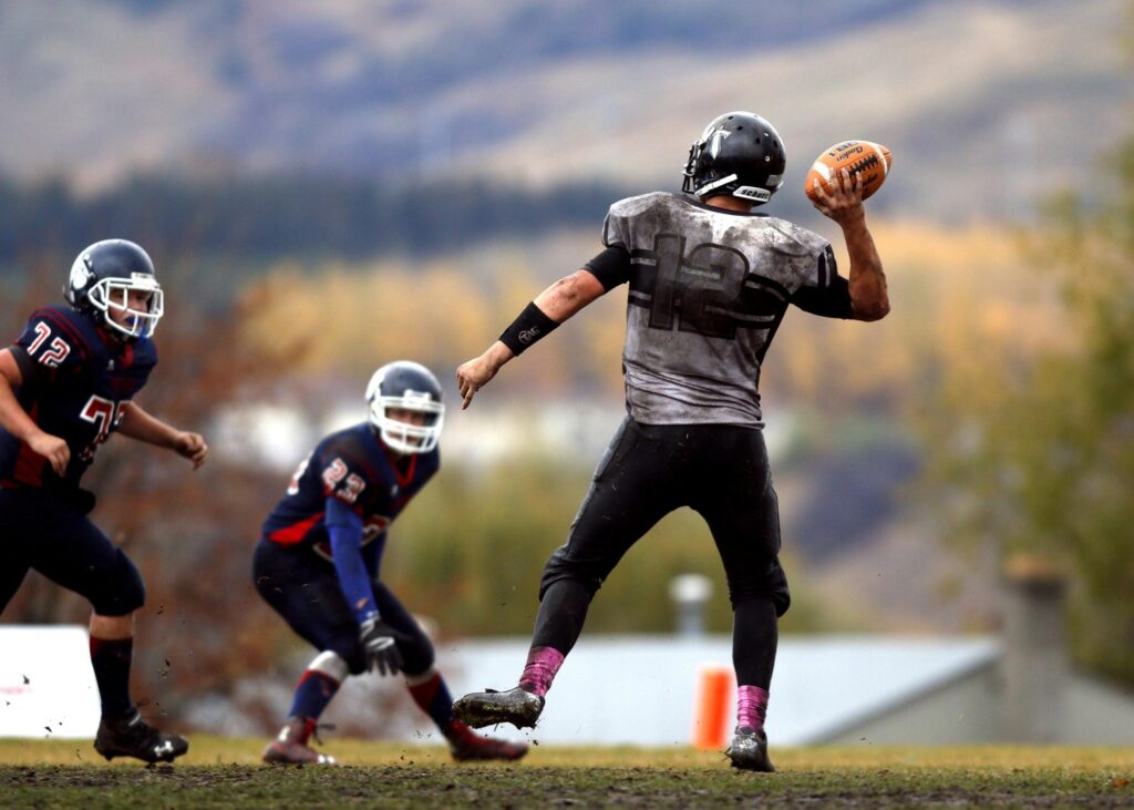 “NFL quarterback making a pass during a football game in 2025 season