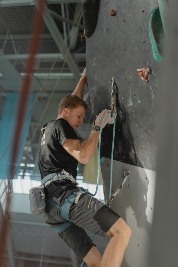 “Olympic sport climber racing up the 15-meter speed wall