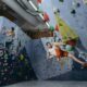 Climber solving bouldering problem during Olympic combined event