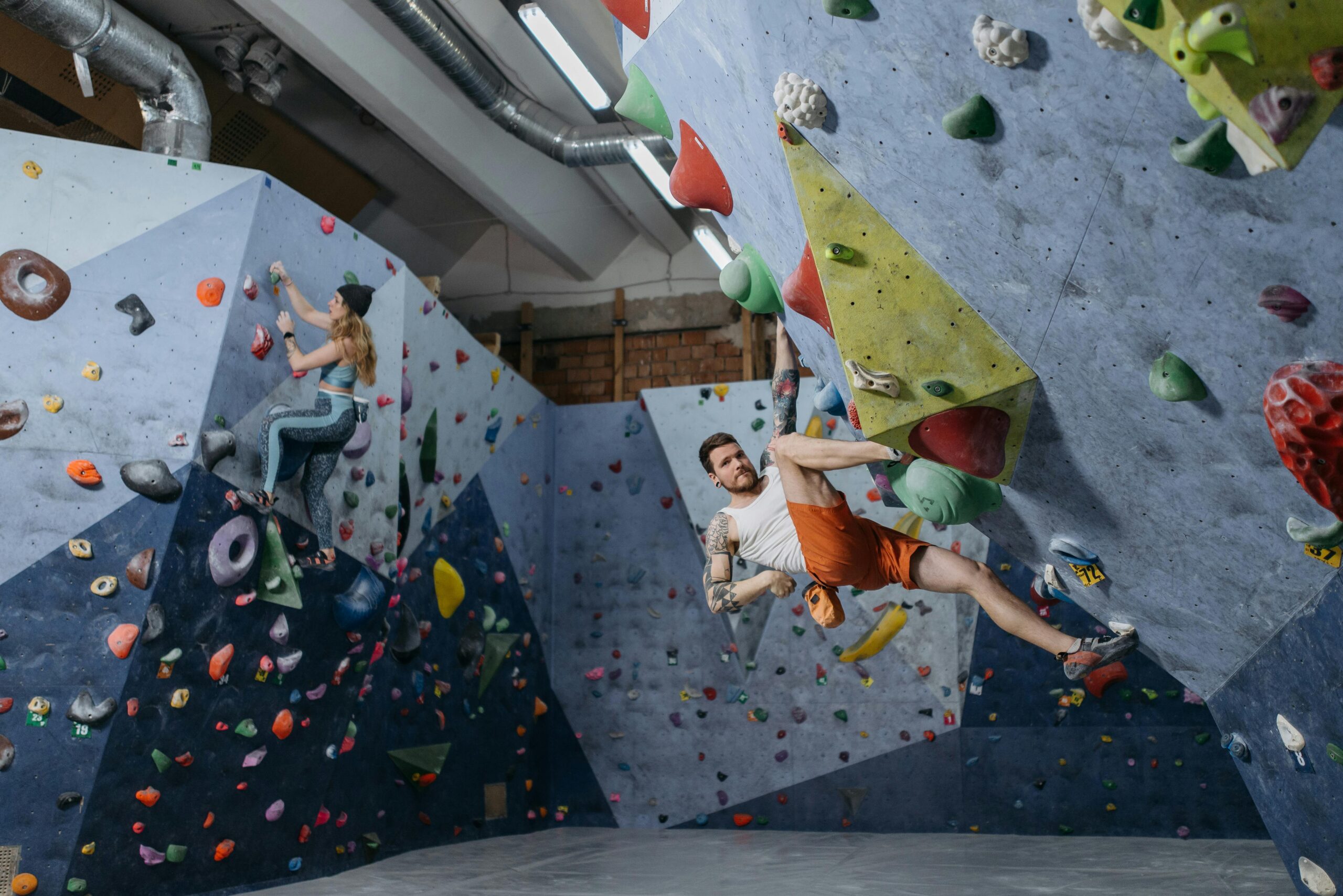Climber solving bouldering problem during Olympic combined event