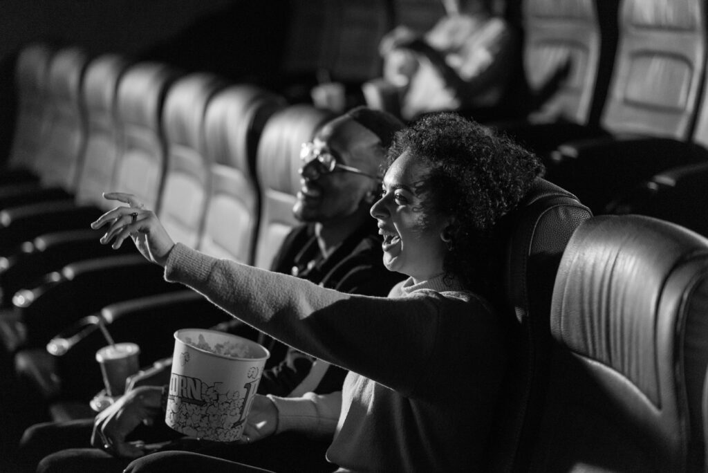 Couple enjoying gourmet food while watching a film