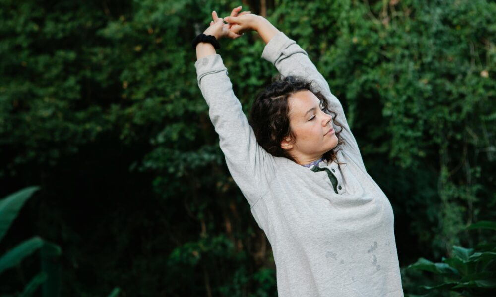 Sunrise with a person stretching near a window, symbolizing a fresh start.
