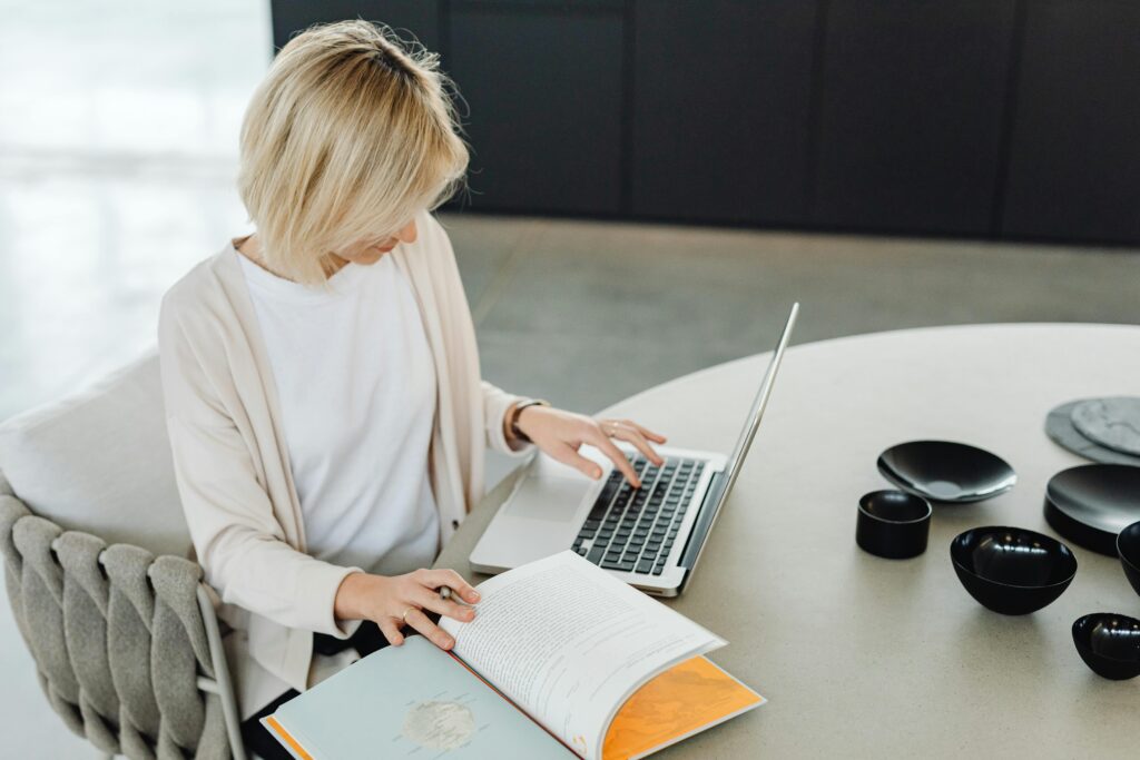 A modern home office setup with a laptop, coffee, and natural lighting.
