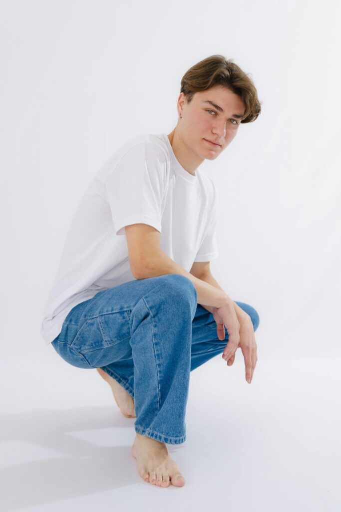 A minimalist flat-lay of neutral clothing (jeans, white T-shirt, sneakers).