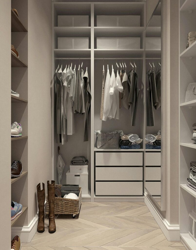 Neatly arranged shirts, chinos, and shoes on a shelf.