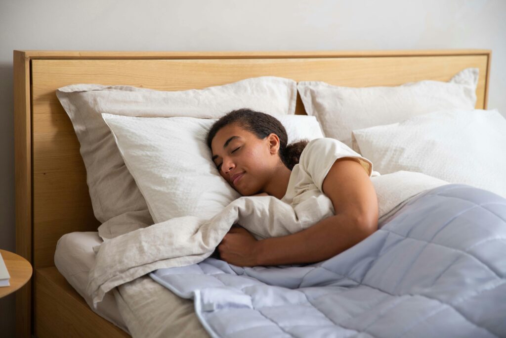 Peaceful woman sleeping in bed for healthy metabolism.