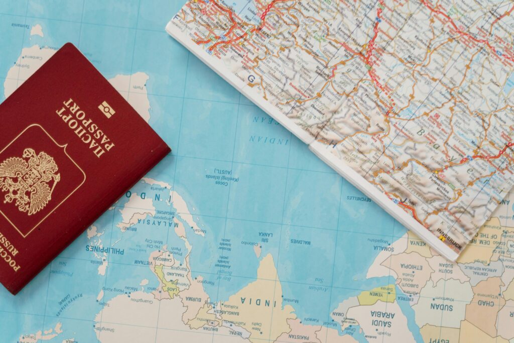 A map and travel essentials (passport, camera, backpack).