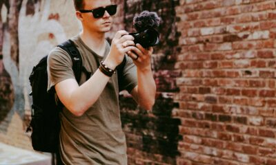 A traveler with a backpack exploring a city on foot.
