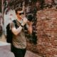 A traveler with a backpack exploring a city on foot.