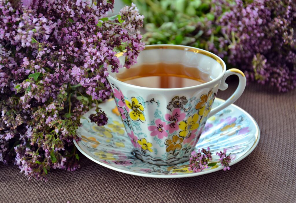 Cup of herbal tea (instead of coffee) on a nightstand.
