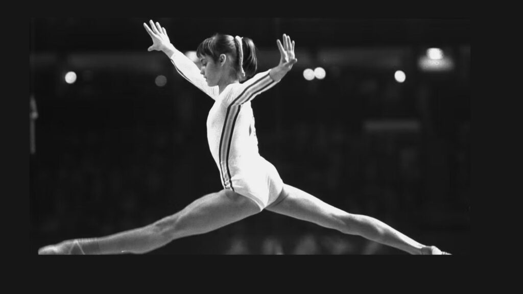 Black-and-white photo of Nadia Comăneci scoring a perfect 10 in 1976.