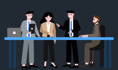 Manager guiding a team in a meeting.