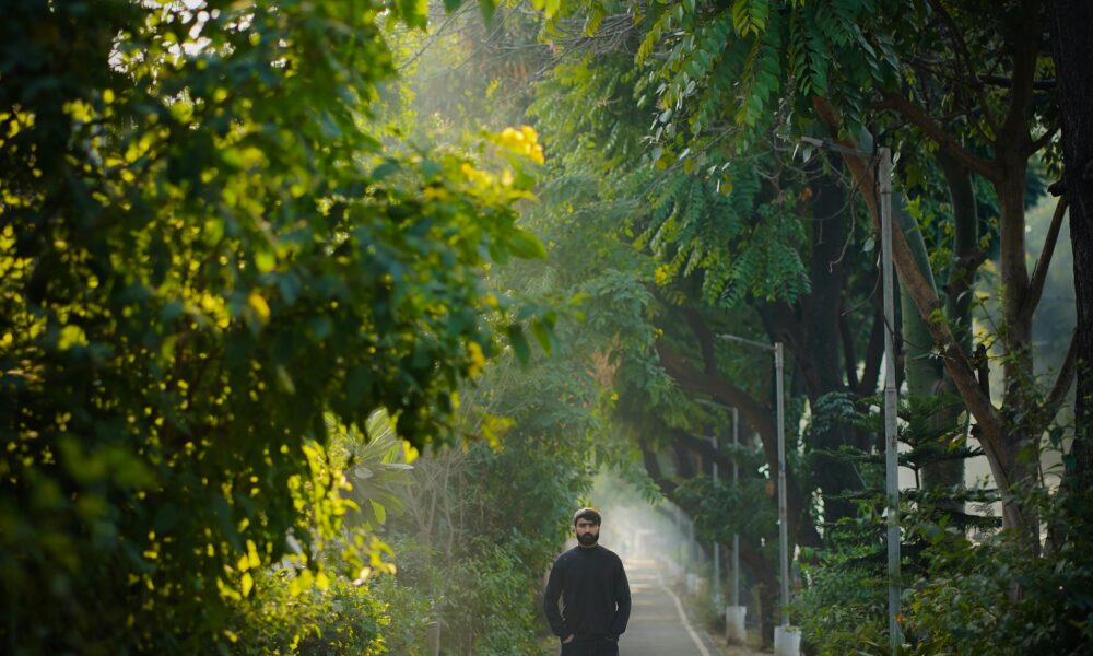 Natural sunlight exposure – person walking outdoors in the morning.