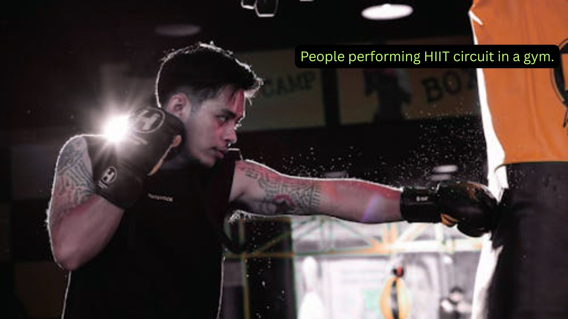 People performing HIIT circuit in a gym.