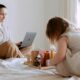 Person balancing work laptop on one side and family time on the other.