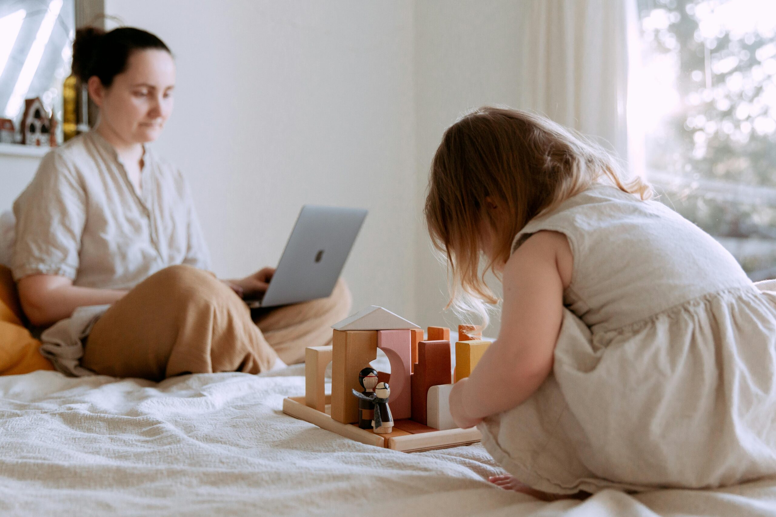 Person balancing work laptop on one side and family time on the other.
