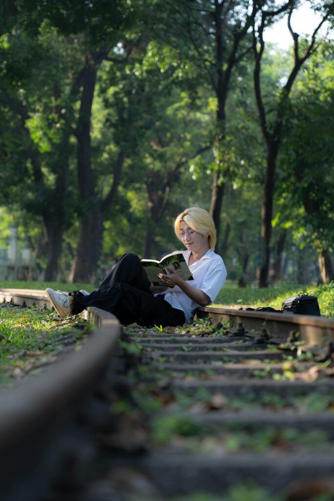 Person meditating, walking in a park, or reading a book.