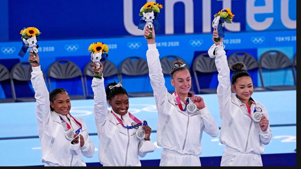 Olympic gymnastics team huddled before a competition.