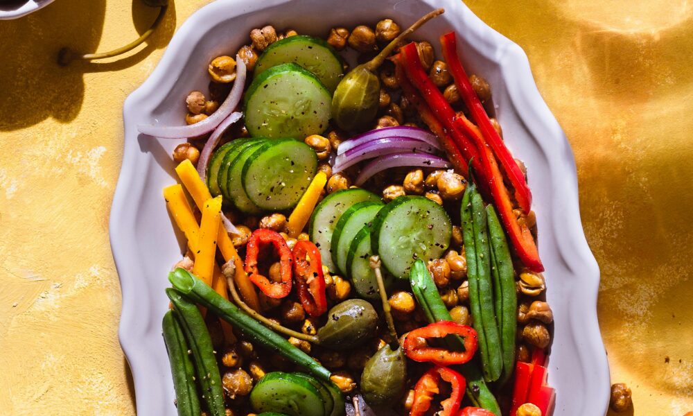 A vibrant bowl of salad with kale, spinach, and colorful veggies.
