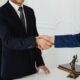 Silk tie being tied in a Windsor knot for business meeting