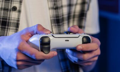 A player holding a bat and a game controller together.