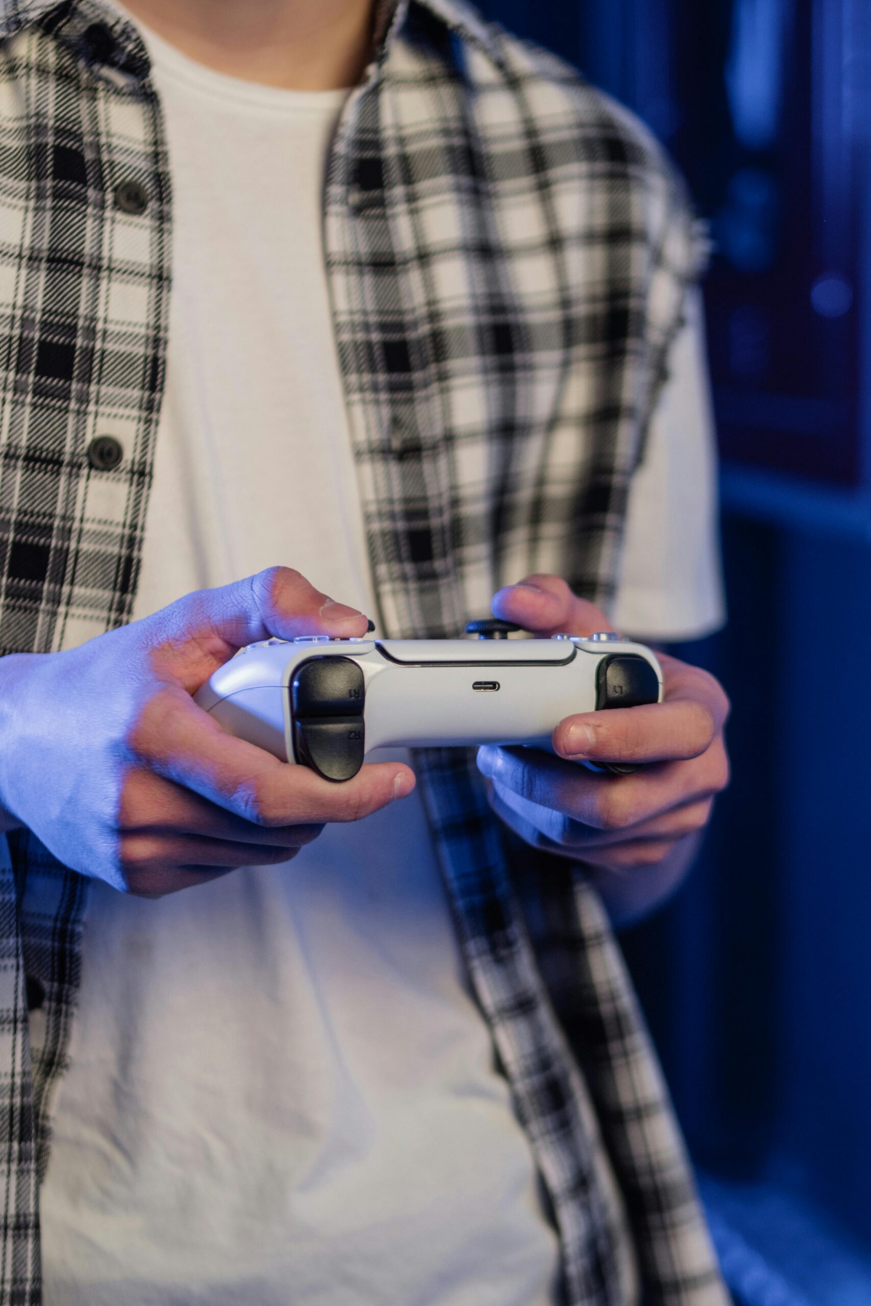 A player holding a bat and a game controller together.