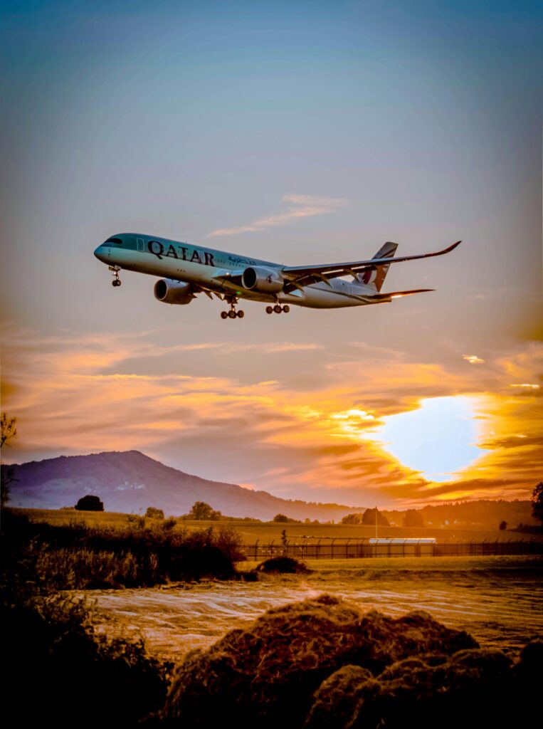 A plane flying at sunset with text overlay “Cheap Flight Hacks.