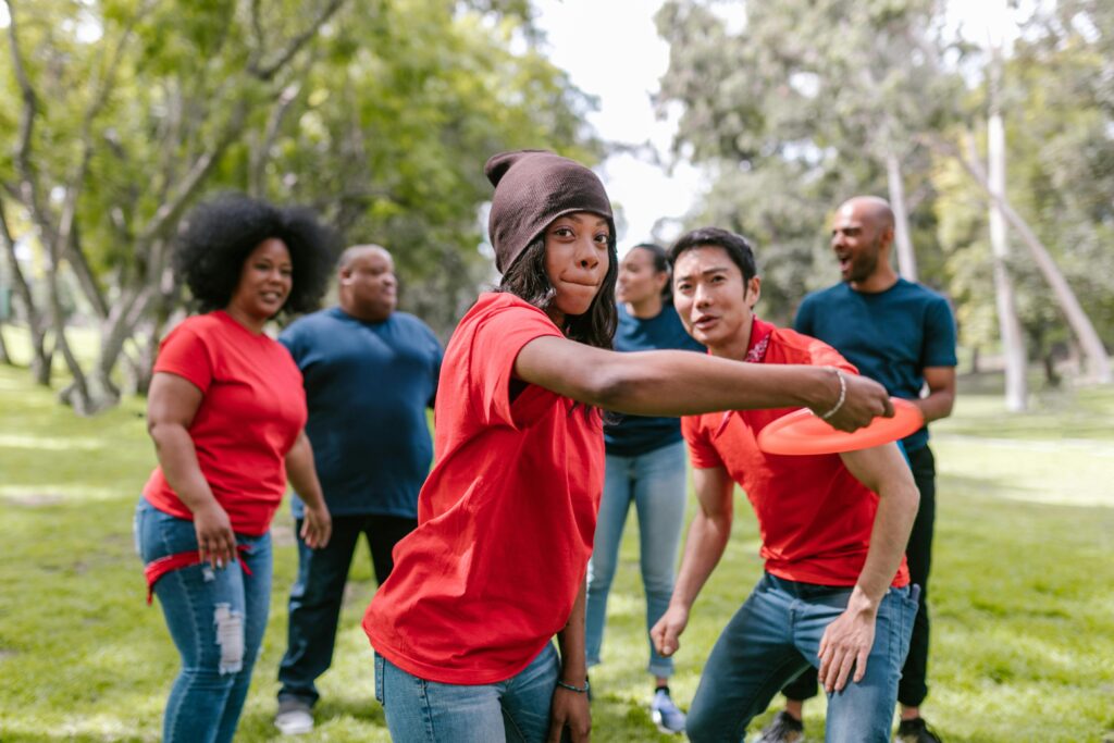 Friends playing frisbee in park