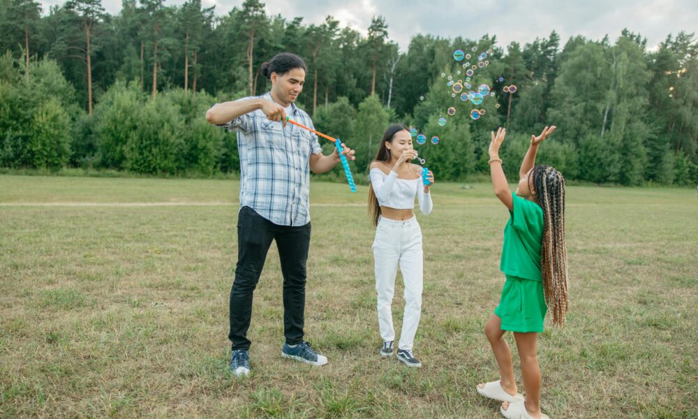 Bright outdoor atmosphere, green grass, sun, smiles
