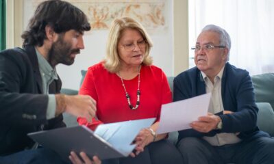 Financial advisor explaining Retirement Savings Contributions Credit to couple.”