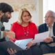 Financial advisor explaining Retirement Savings Contributions Credit to couple.”
