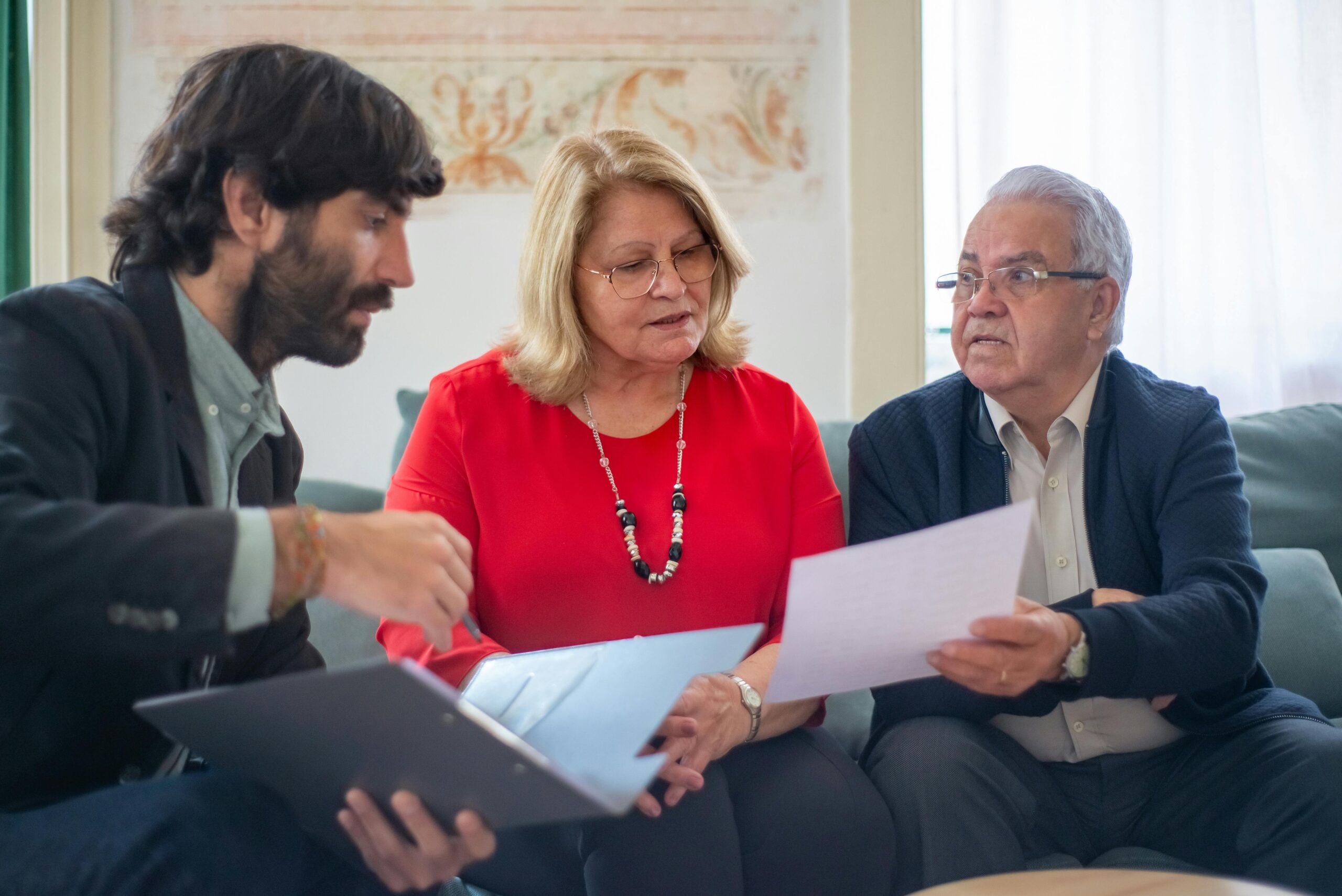 Financial advisor explaining Retirement Savings Contributions Credit to couple.”