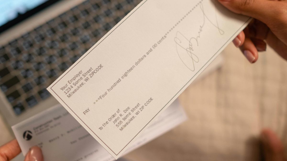 How to write a check step by step with example showing date, payee, amount in numbers and words, memo, and signature