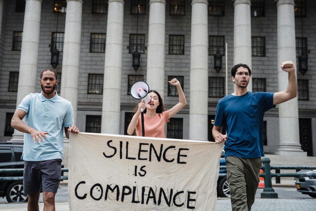 Diverse group of people holding banners at a protest.