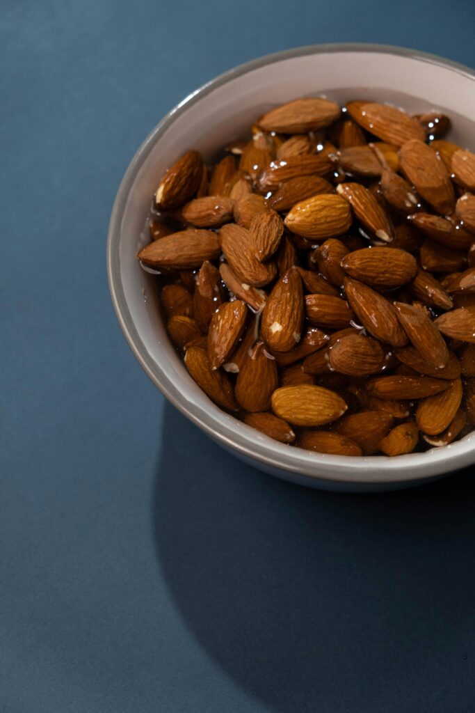 A close-up shot of soaked almonds in a bowl.
