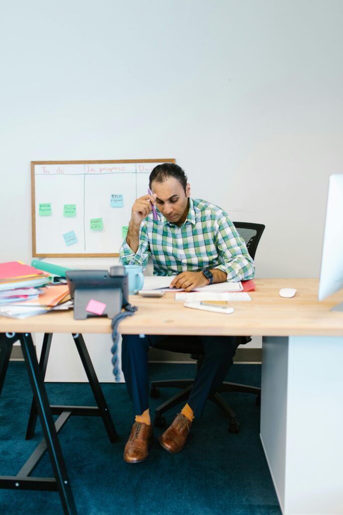 Office setting showing stressed employee at desk