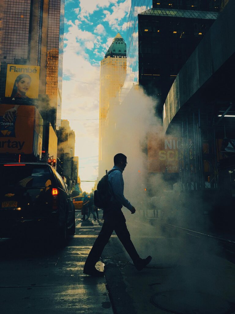 Cars and buses emitting smoke during rush hour.