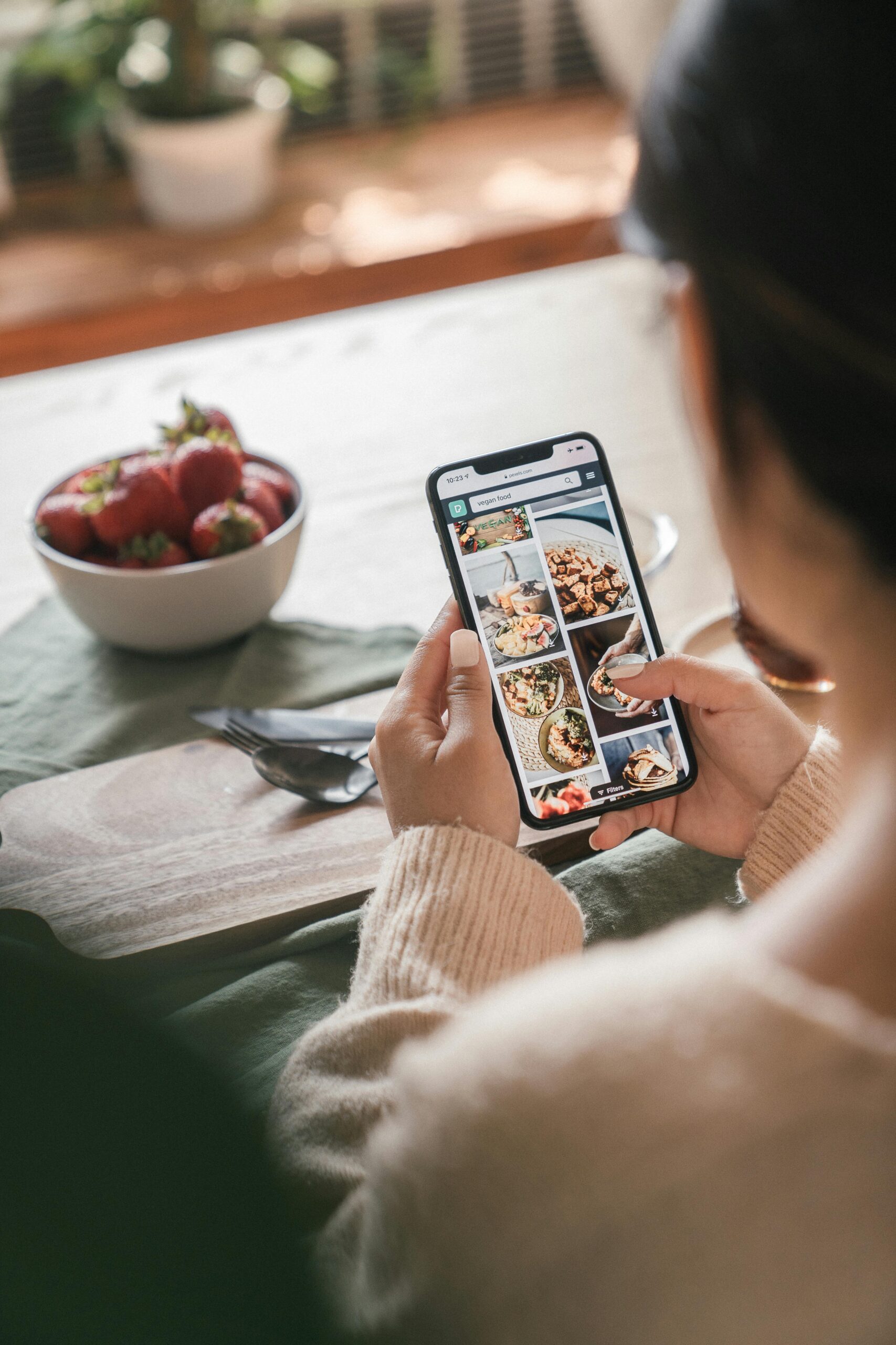 Young person using a smartphone to order fast food via app.