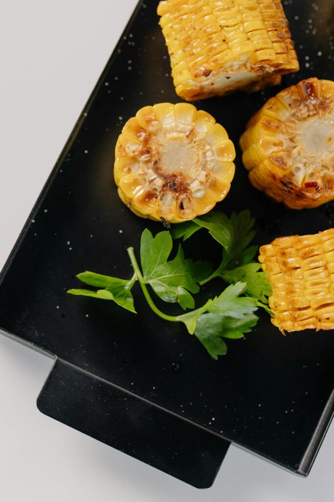 Loaded grilled corn with cheese and spices at a BBQ