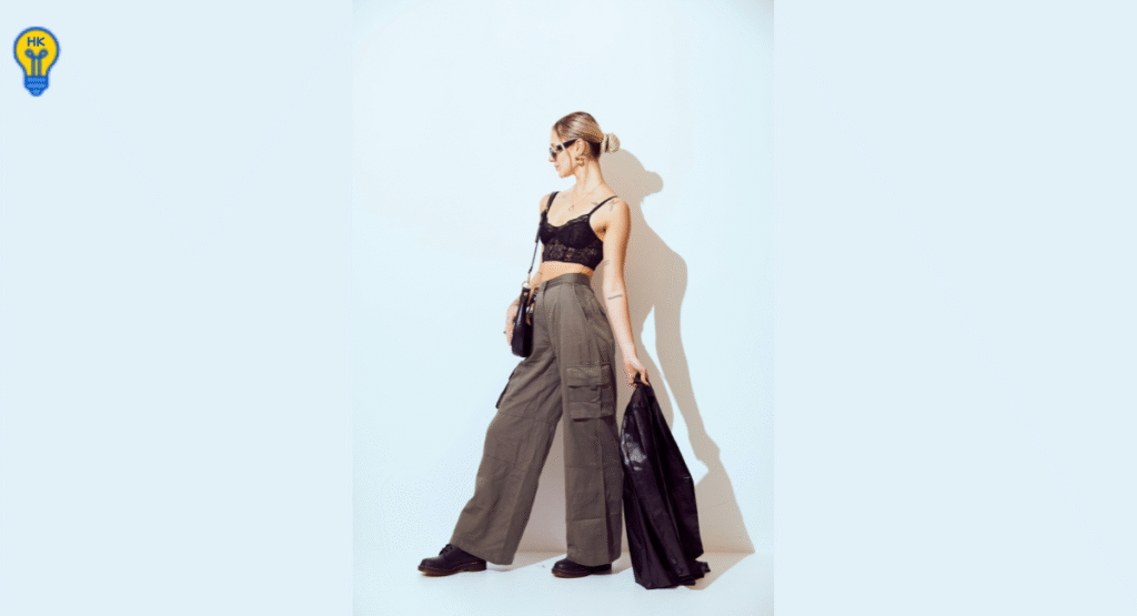 Utility dressing trend SS26 with cargo trousers, pocket-laden shorts, and leather bomber jacket in urban fashion setting